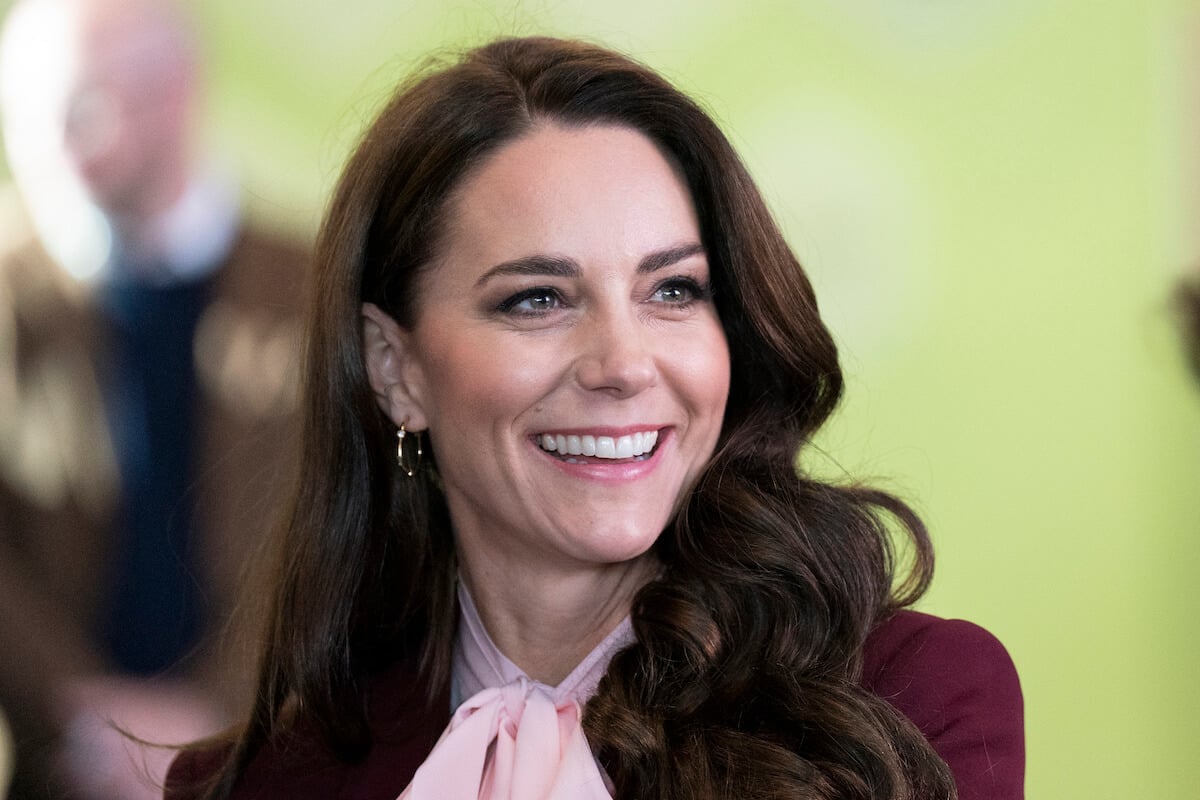 Kate Middleton wears a pantsuit and smiles