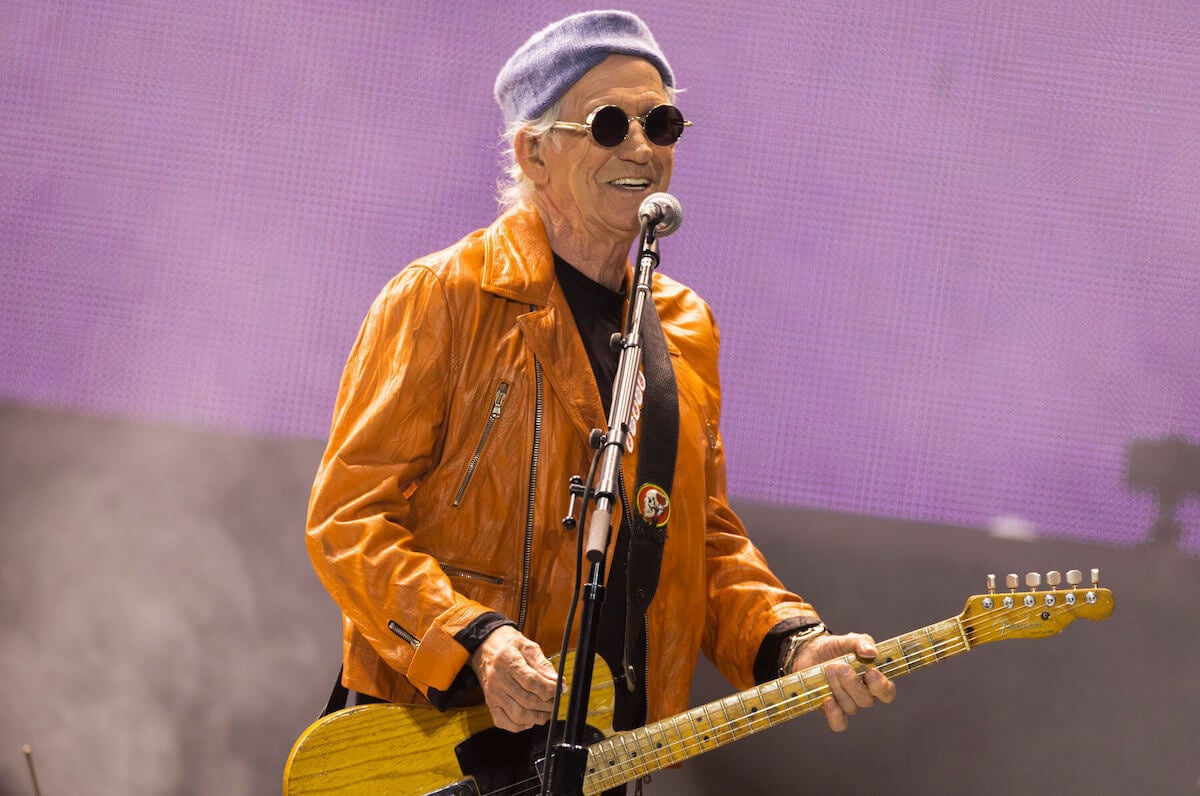 Keith Richards performs on stage, smiling