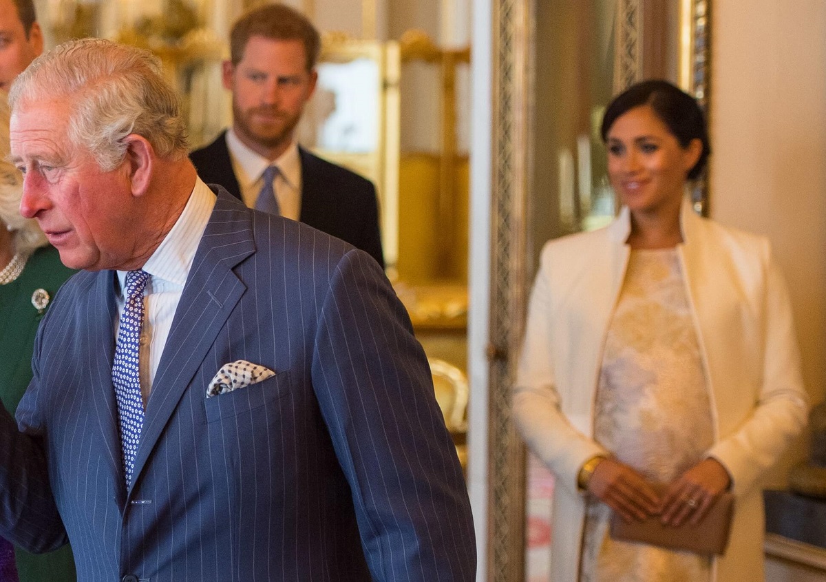 King Charles III with Prince Harry and Meghan Markle, who may make a mistake of they don't attend coronation, at a reception at Buckingham Palace