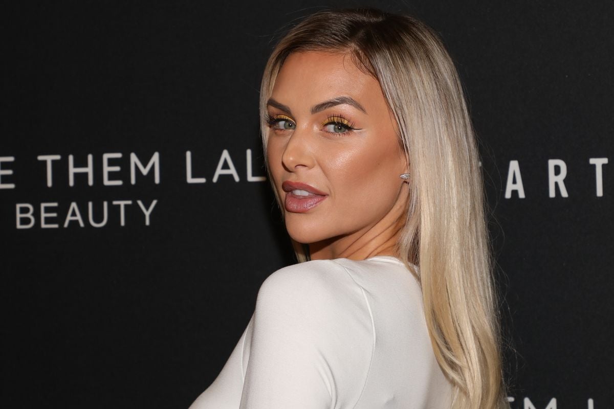 Lala Kent poses for photos at an event.