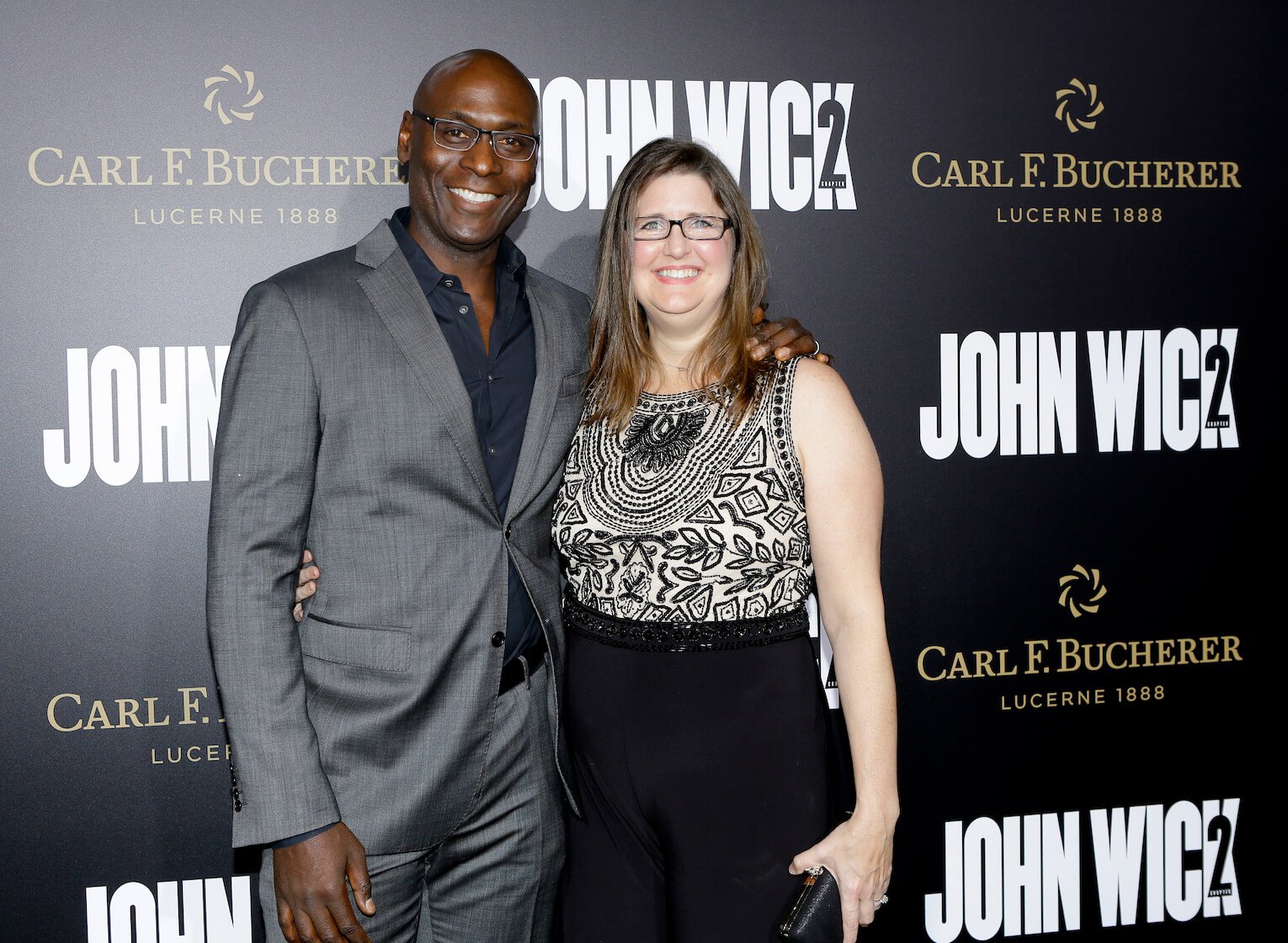 Lance Reddick and wife Stephanie Reddick smiling at an event