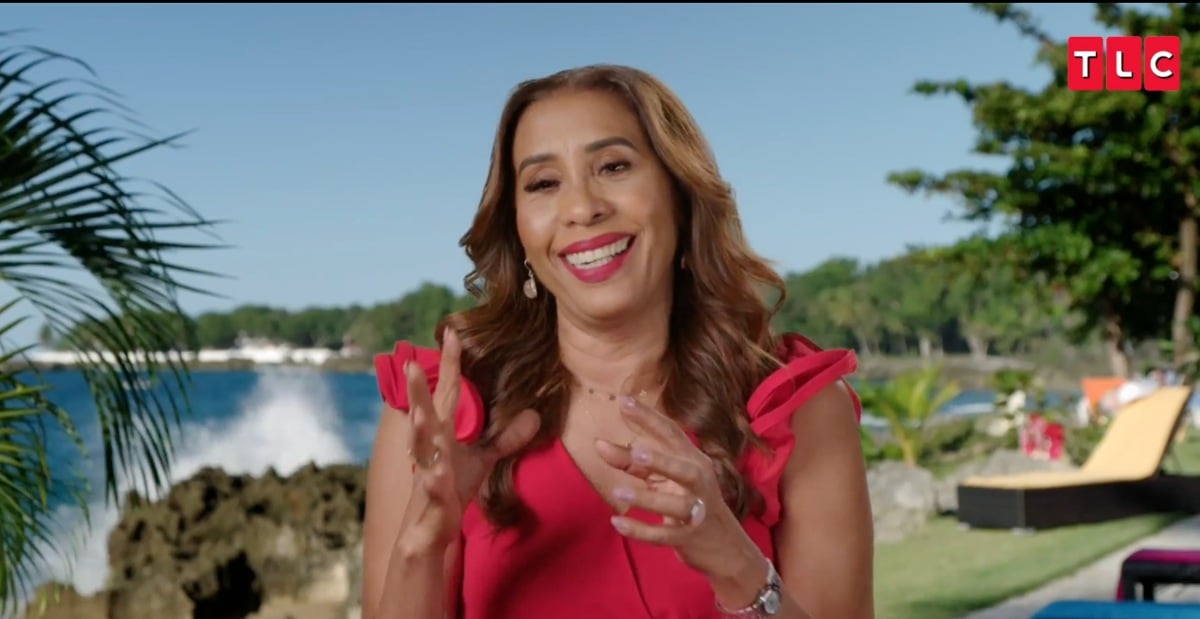 Lidia Jimeno smiling in a red dress on '90 Day Fiancé: Love in Paradise' Season 3 on TLC.