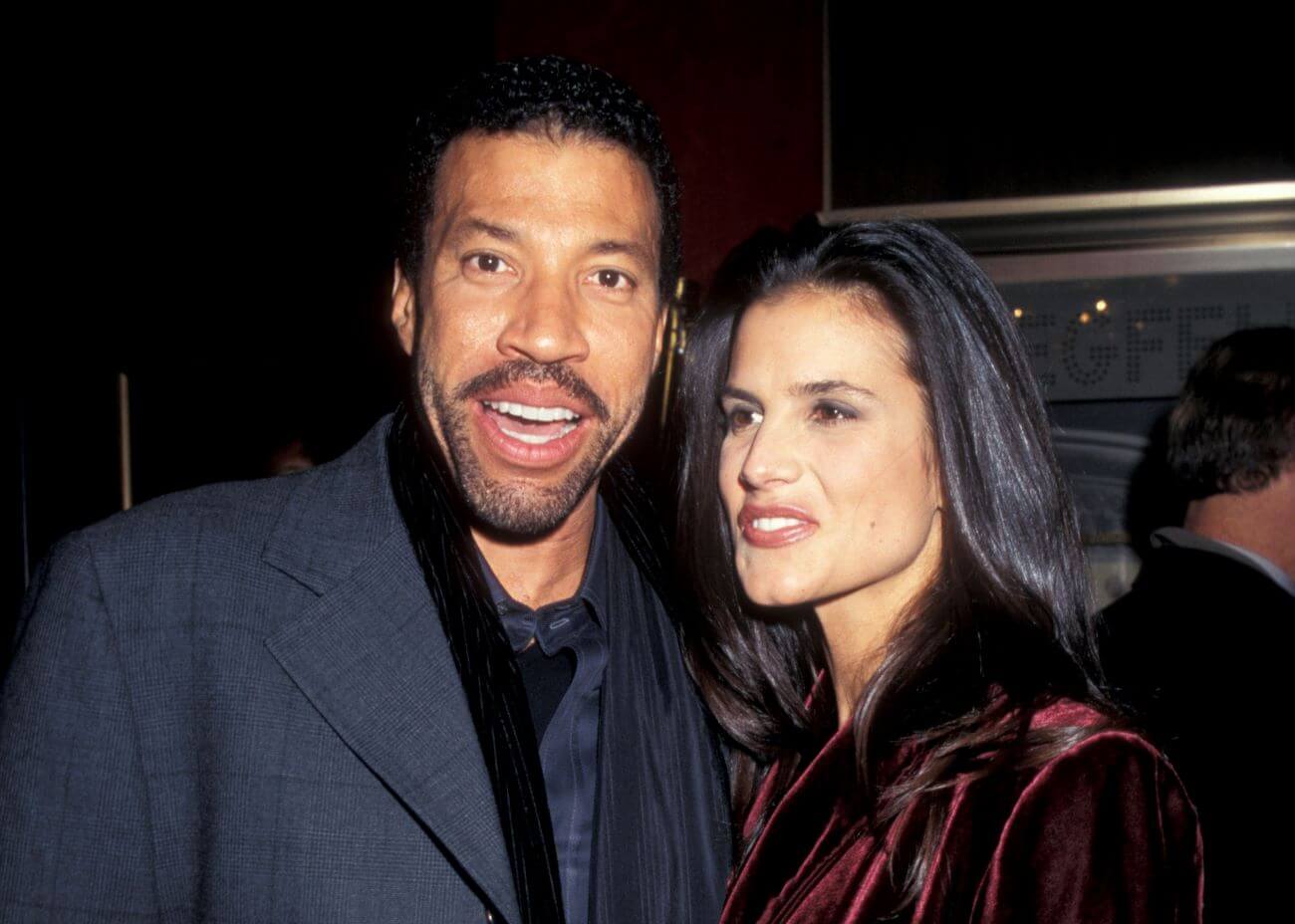 Lionel Richie and Diane Alexander wear coats outside of a theater.