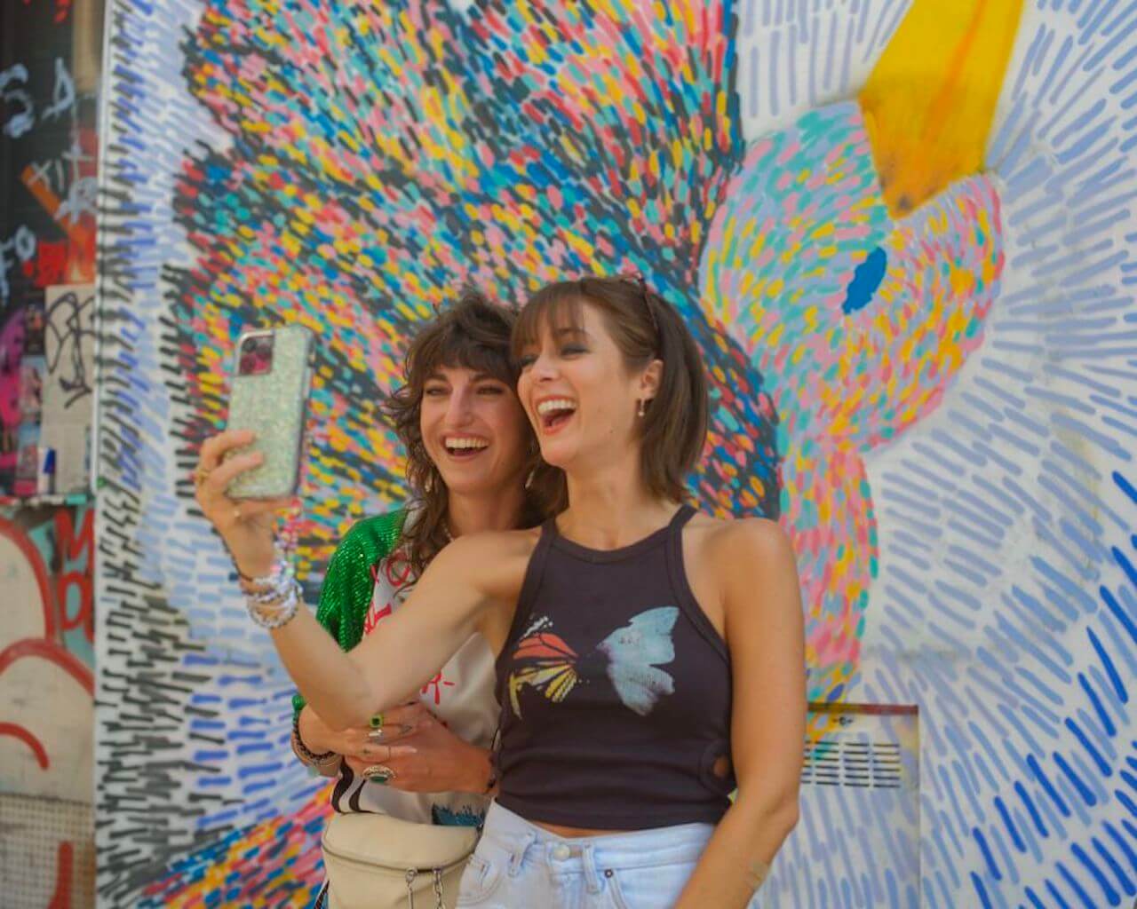 Joséphine and Lacy Hartselle take a picture in front of a mural on 'Love Trip: Paris'.