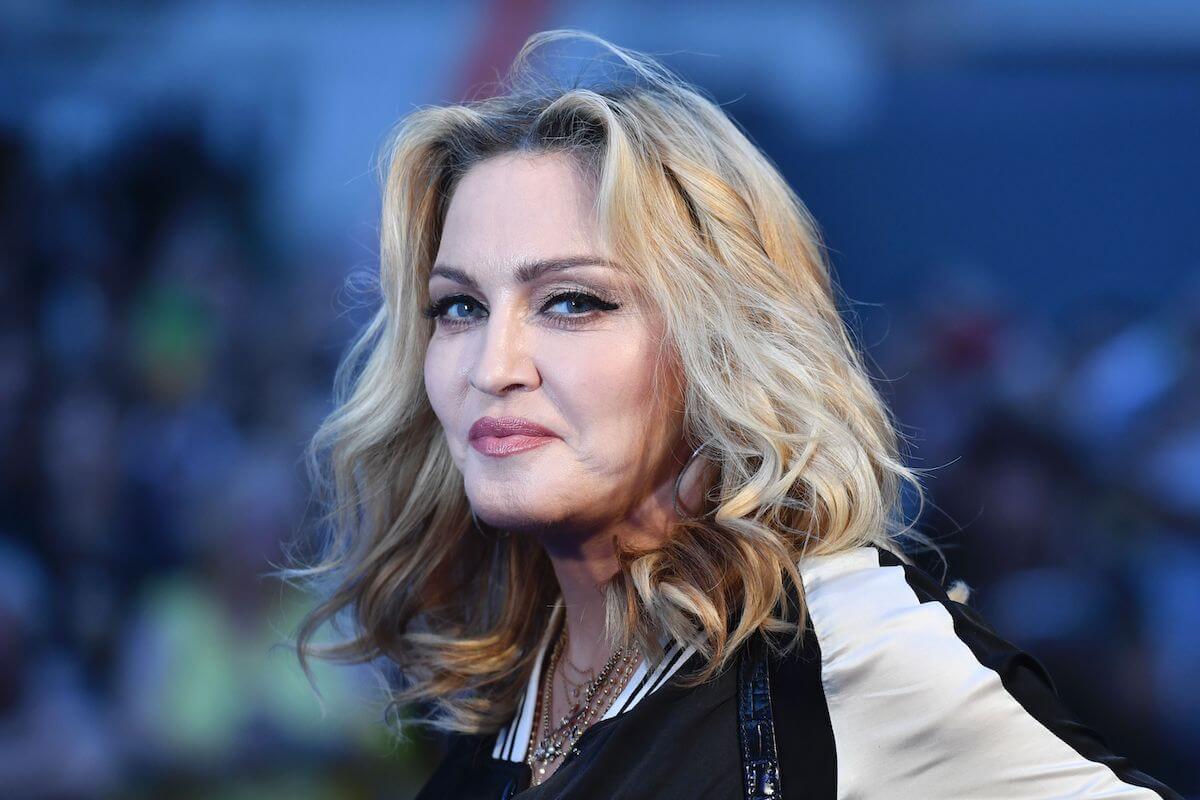 Madonna smiling with a blue background