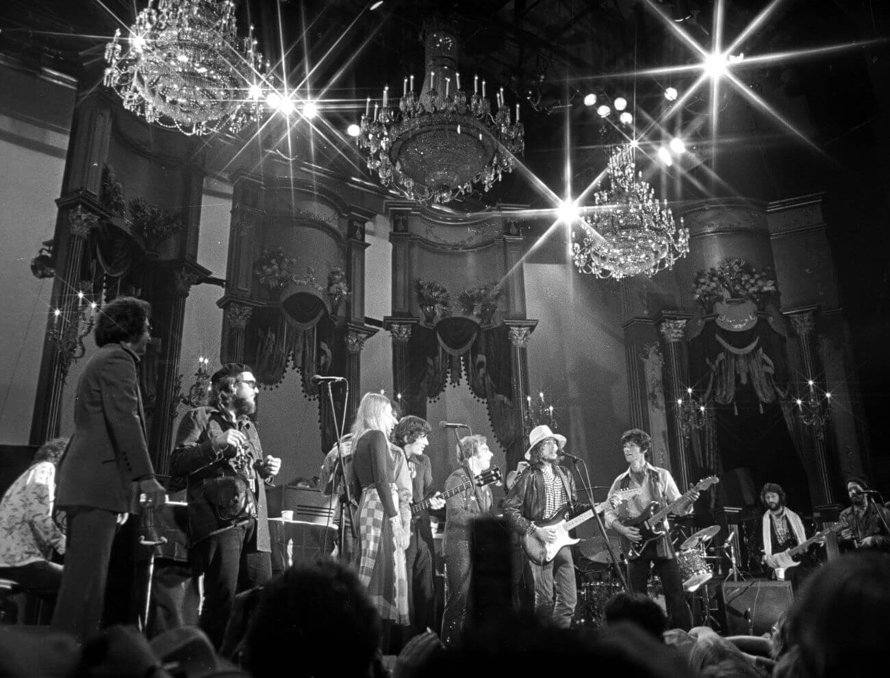 A black and white picture of Bob Dylan onstage with Van Morrison, Joni Mitchell, The Band and other musicians in Martin Scorsese's music documentary 'The Last Waltz.'