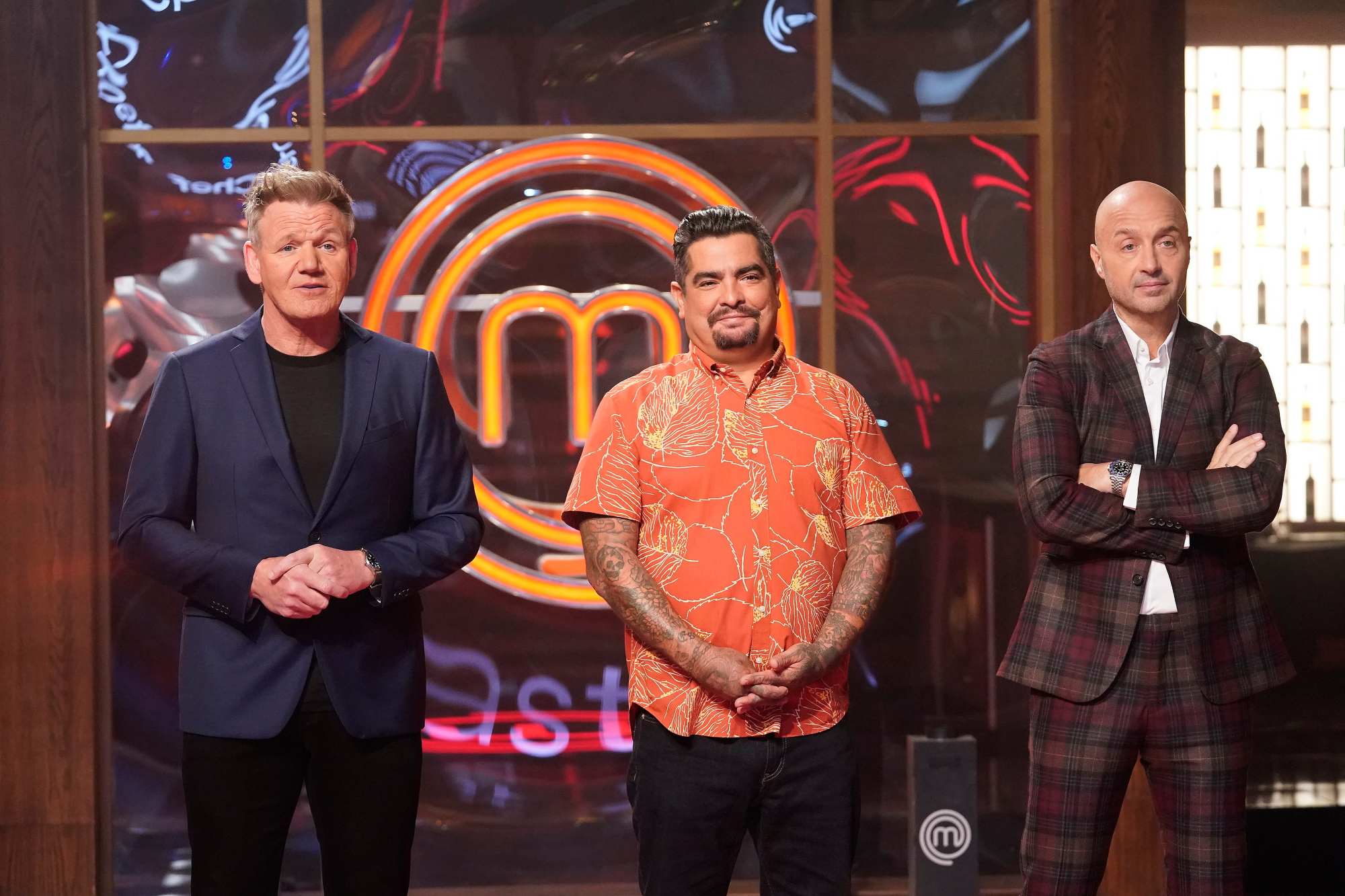 'MasterChef' judge Gordon Ramsay, Aarón Sánchez, and Joe Bastianich standing side-by-side in front of the show's logo.