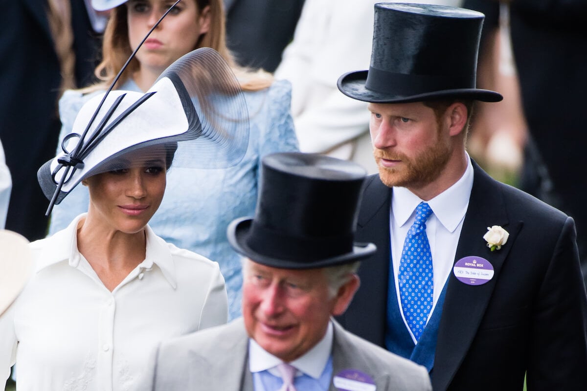 Meghan Markle and Prince Harry, whose coronation demand regarding palace balcony is unlikely, stand behind King Charles