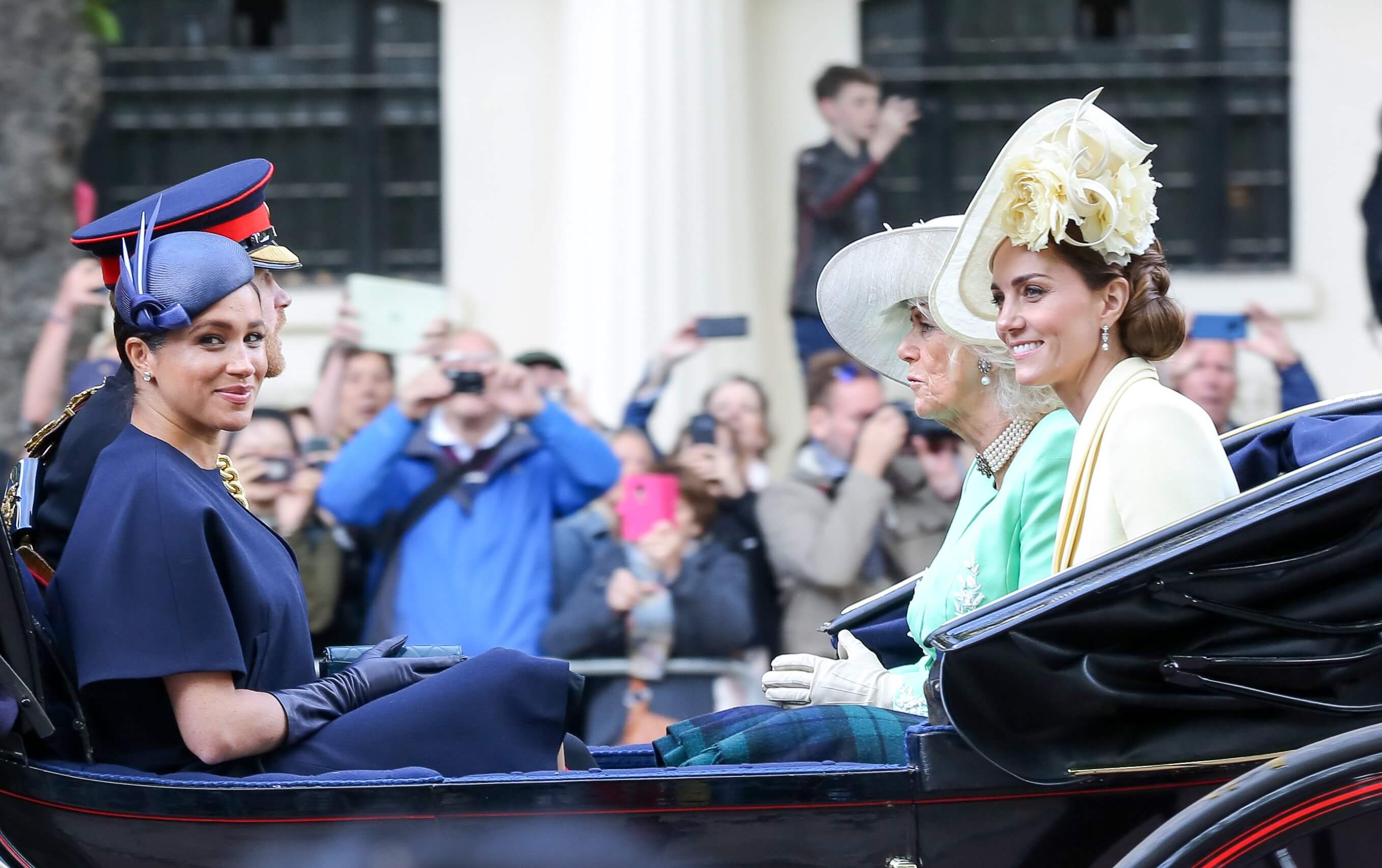 Meghan Markle and Kate Middleton, who handled the press differently, are seen in a carriage with Prince Harry and Camilla Parker Bowles after Trooping the Colour in 2019