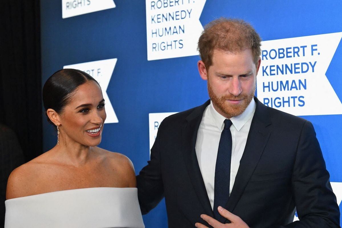 Meghan Markle and Prince Harry, who made a suprise London court appearance, walk together