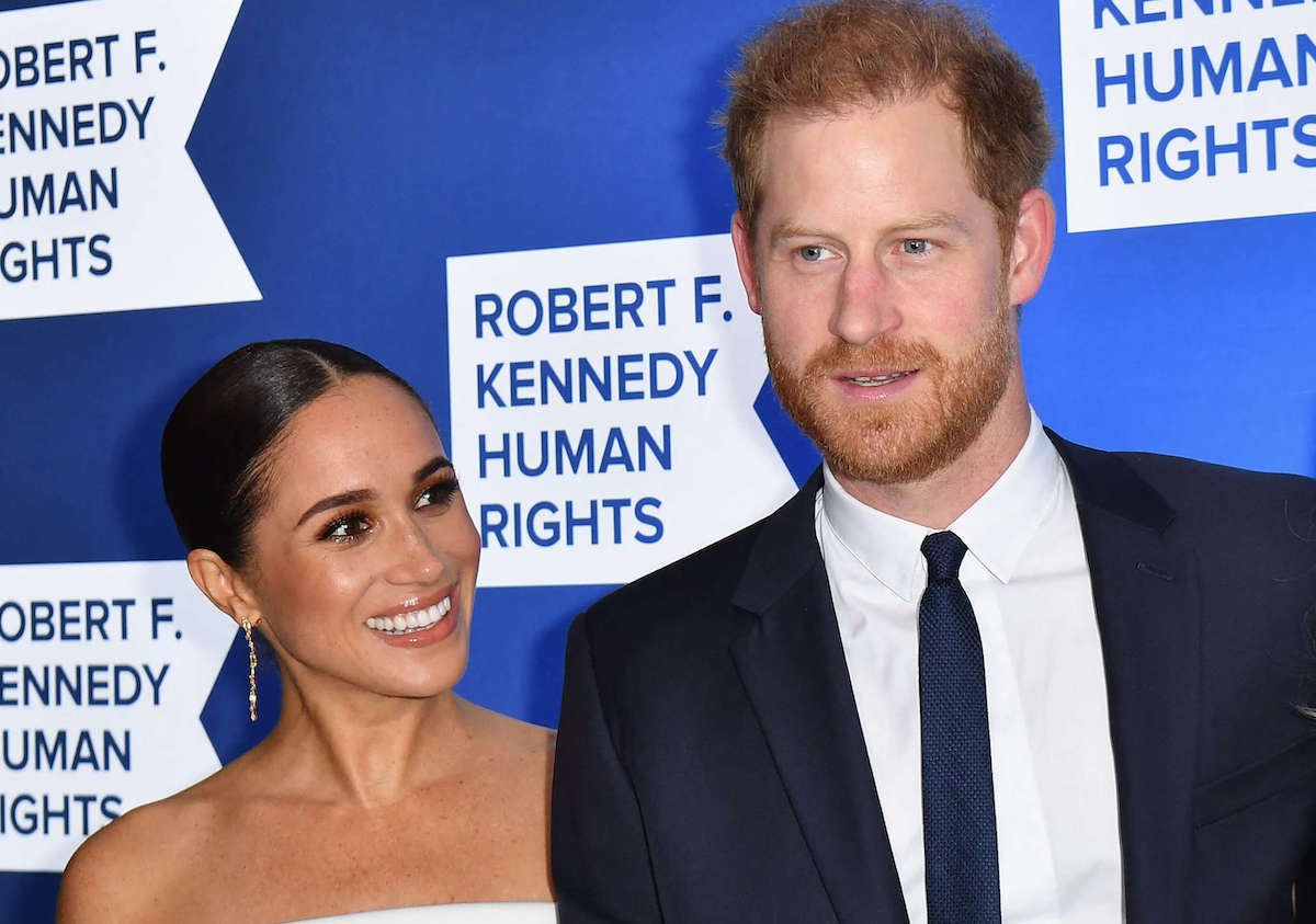 Meghan Markle and Prince Harry, who got in a 'tiff' about Archie's birth announcement, look on
