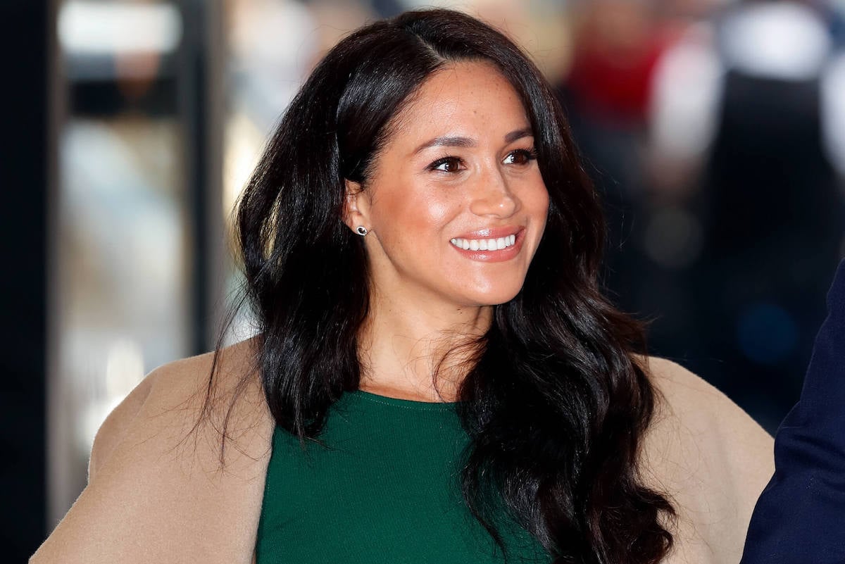 Meghan Markle, who has worn green along with Kate Middleton, smiles