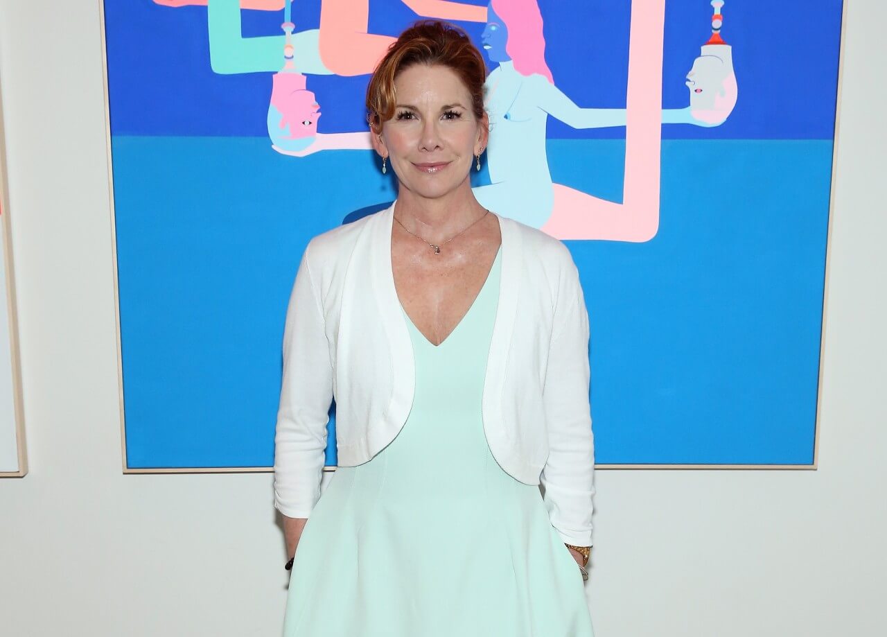 Melissa Gilbert poses in a mint green dress during a media event. 