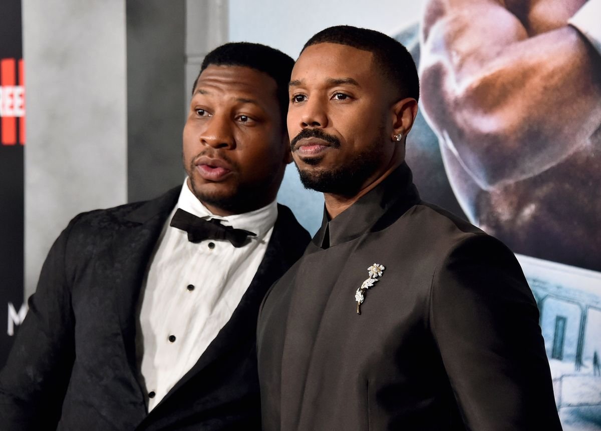 Jonathan Majors and Michael B. Jordan pose for photos at the premiere of "Creed III"