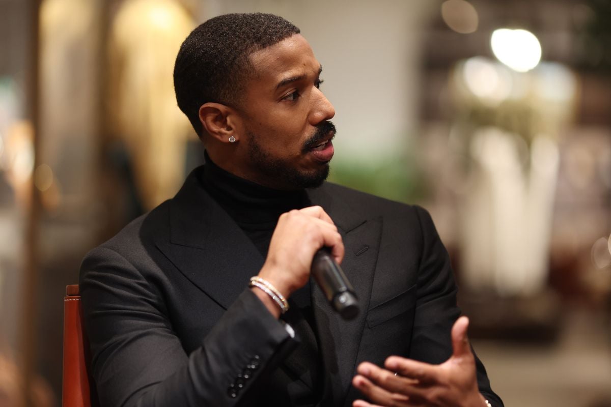 Michael B. Jordan speaks into a microphone.