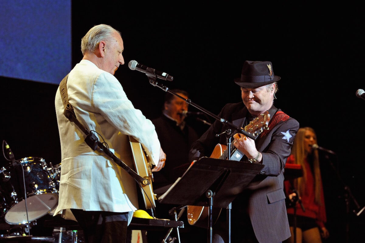 Michael Nesmith and Micky Dolenz of The Monkees playing guitars onstage
