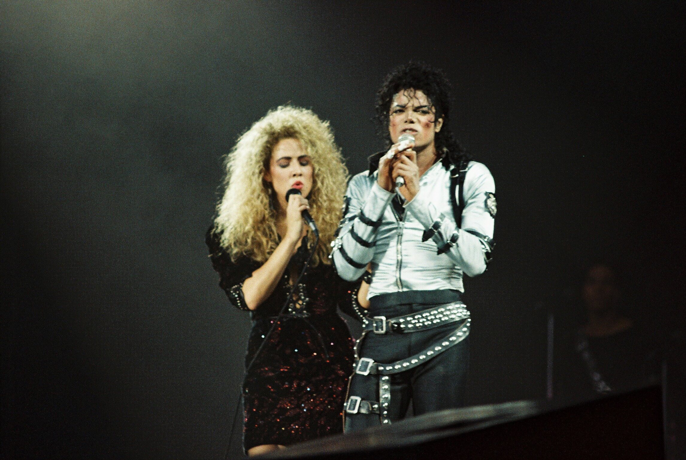 Sheryl Crow (L) joins Michael Jackson (R) to perform on stage on his BAD tour at Wembley Stadium