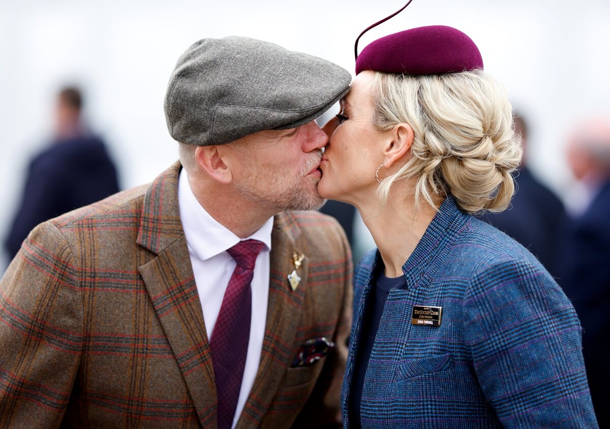 Mike Tindall and Zara Tindall kiss as they attend day 3 'St Patrick's Thursday' of the Cheltenham Festival
