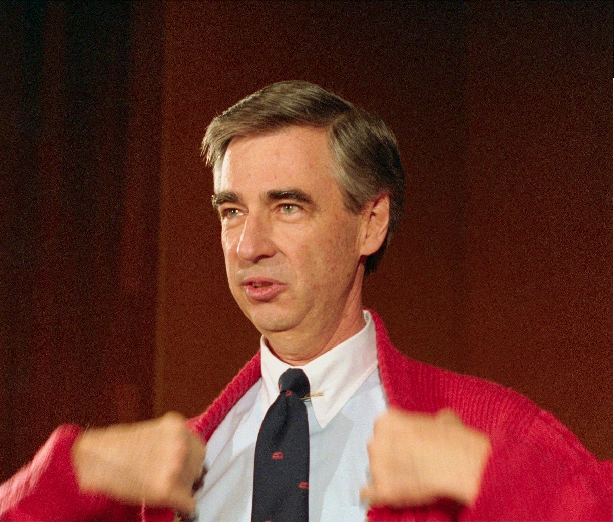 Fred Rogers in his famous red cardigan at an event