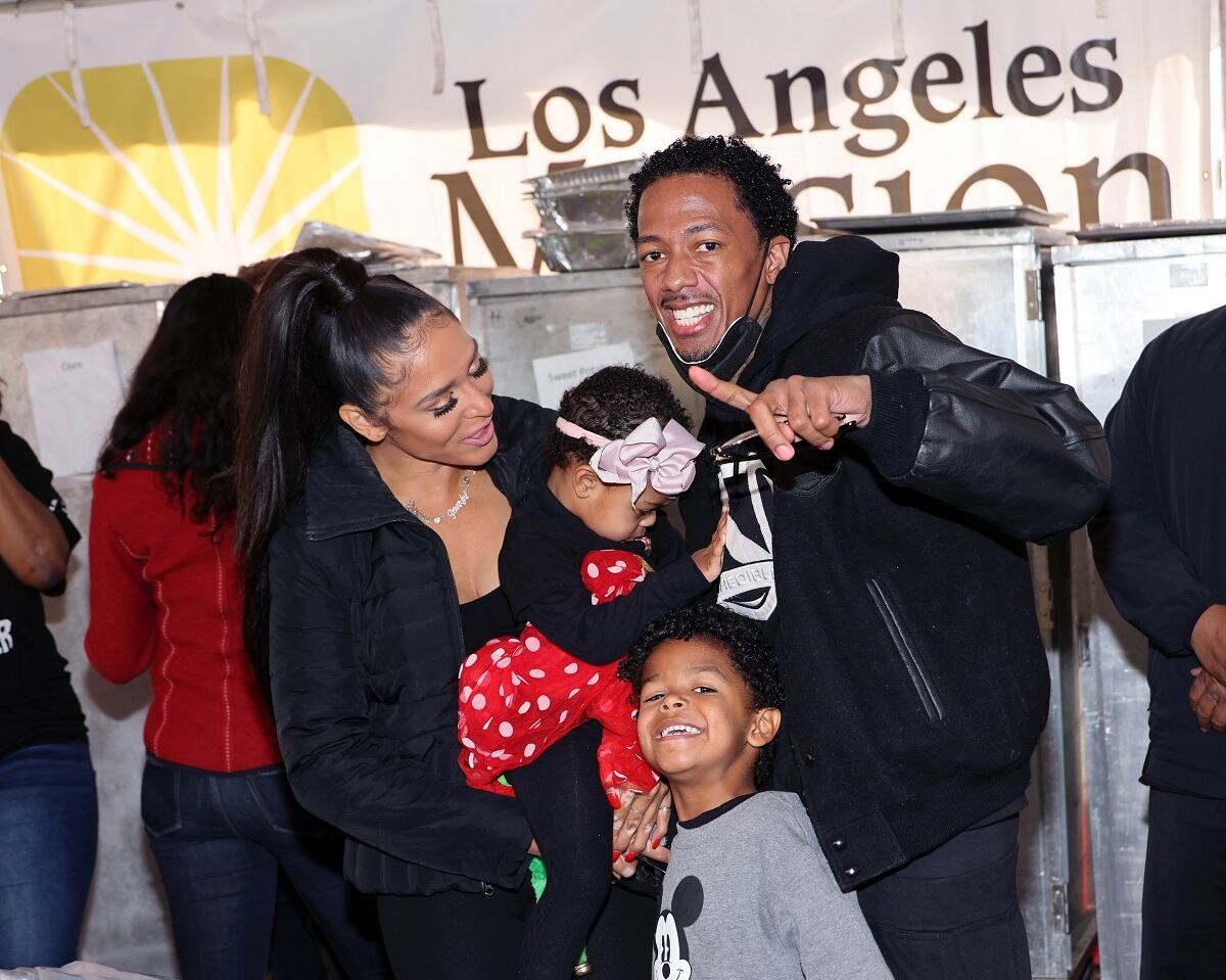 Brittany Bell, Nick Cannon and two of their three kisda attend the Los Angeles Mission's Annual Christmas Celebration in December 2022