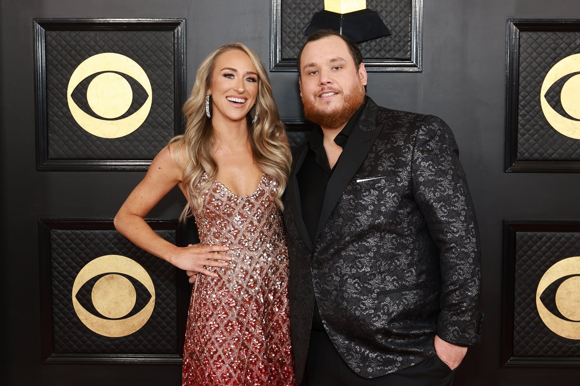 Nicole Hocking in a pink bedazzled dress with Luke Combs in a black suit