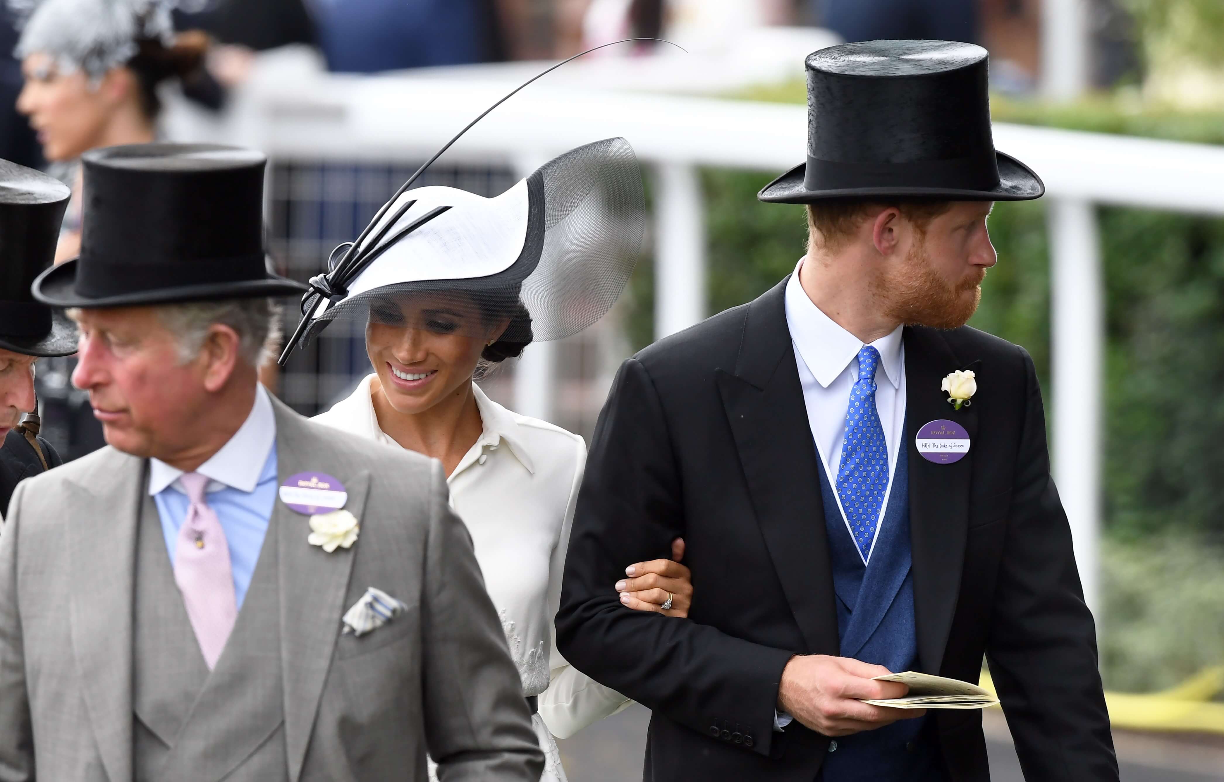 Now-King Charles III, Meghan Markle, and Prince Harry attend the first day of Royal Ascot on 2018