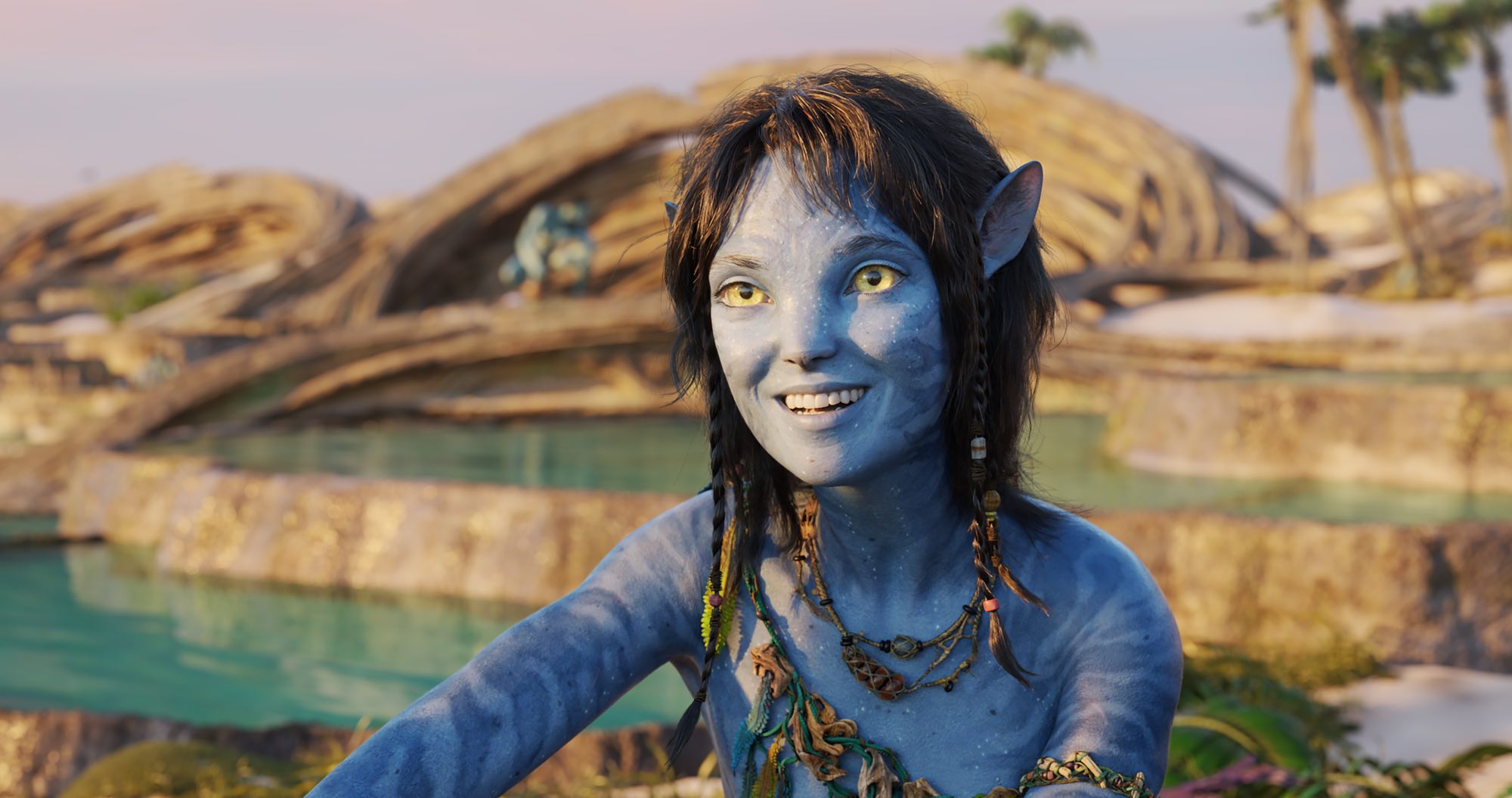 Oscars 2023 Best Picture nominee 'Avatar: The Way of Water' Sigourney Weaver as Kiri smiling in front of pools of water.