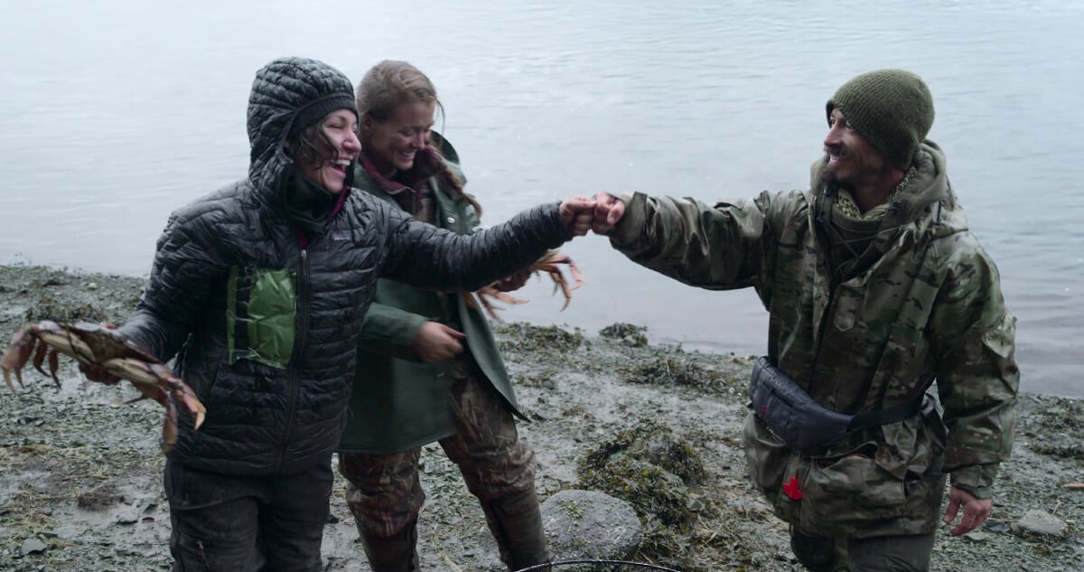 During Outlast Episode 3, Jill Ashock, Amber Asay, and Justin Court celebrate catching crabs. 
