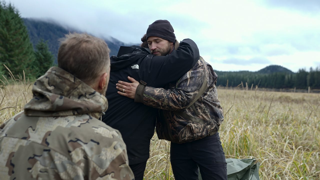 Joel Huntgate and Dawn Nelson hug beside Paul Preece on 'Outlast'.