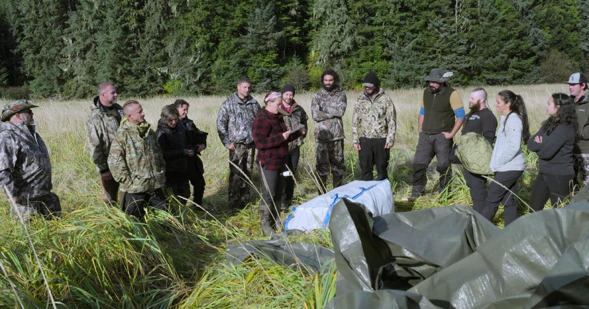 The cast of Outlast Season 1 gathers around the first parachute.