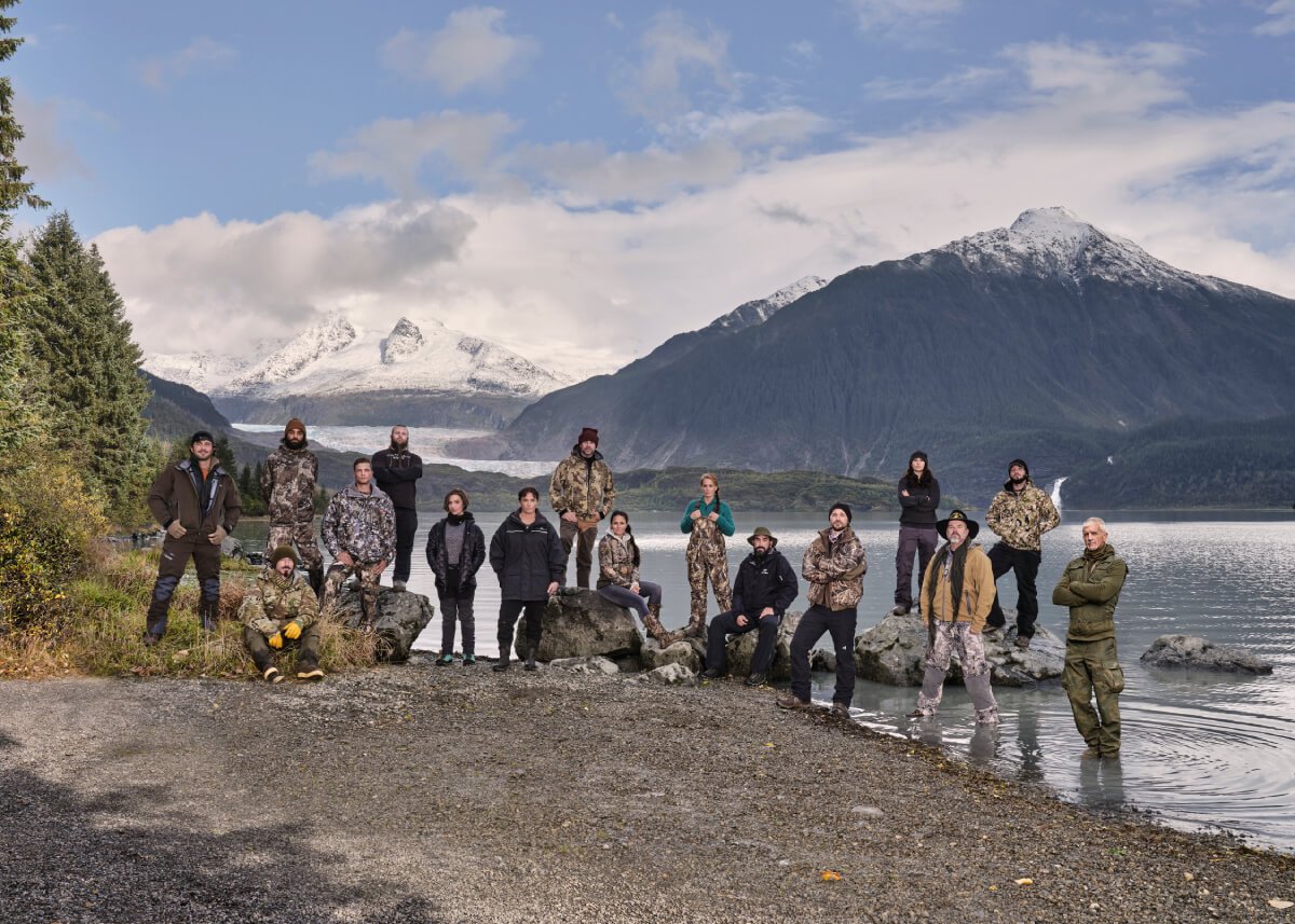 The cast of Outlast Season 1 poses beside a river in Alaska.