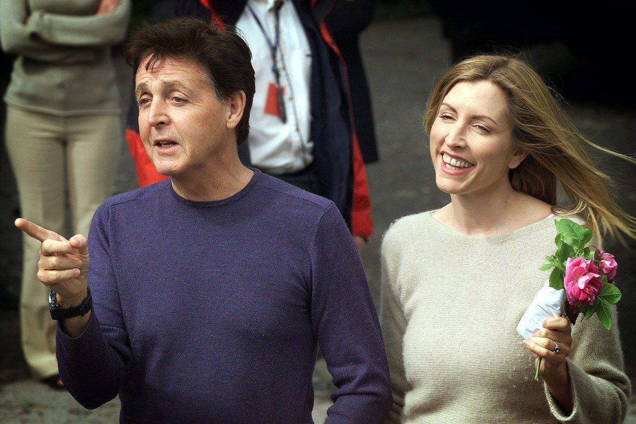 Paul McCartney (left) points with his right hand as he and future wife Heather Mills make an appearance before their wedding.