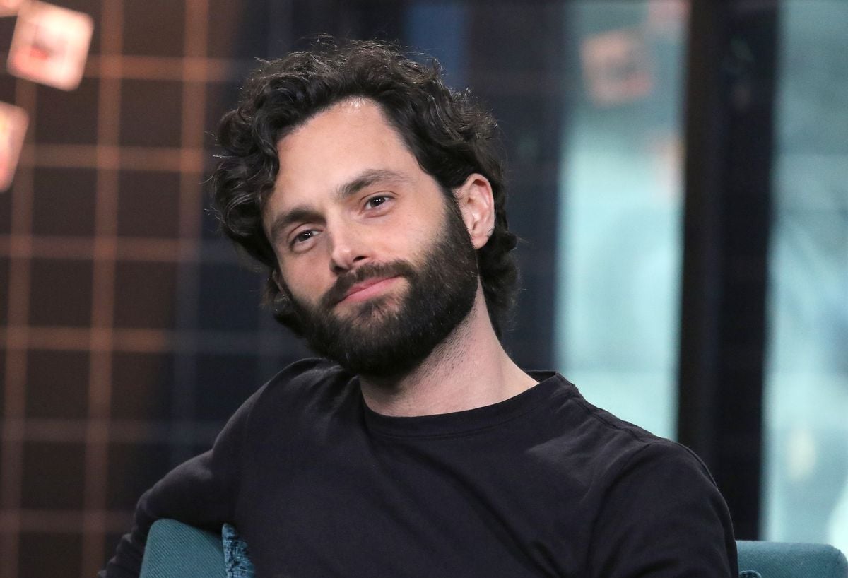 Penn Badgley answers questions during an interview.