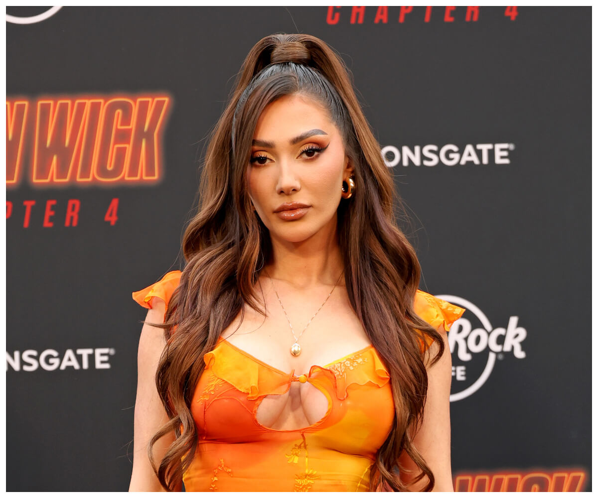 "Perfect Match" star Francesca Farago poses in an orange dress at an event.