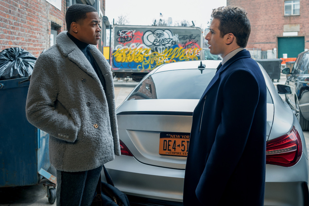 Michael Rainey Jr. as Tariq St. Patrick and Gianni Paolo as Braydon Weston conversing outside near a Mercedes Benz in 'Power Book II: Ghost'