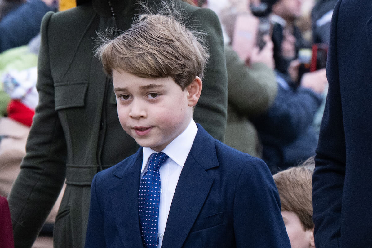 Prince George, who a body language expert says looks up to his cousin, Savannah Phillips, looks on