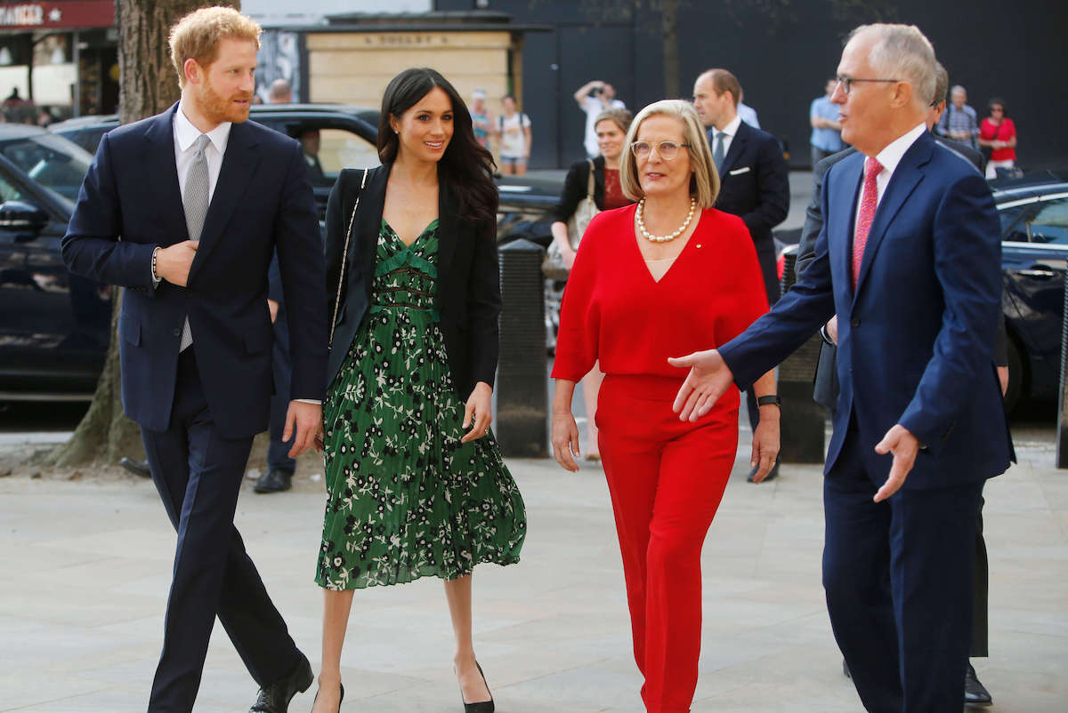 Meghan Markle wears a green dress as she walks with Prince Harry, former Australia Prime Minister Malcolm Turnbull, and Lucy Turnbull