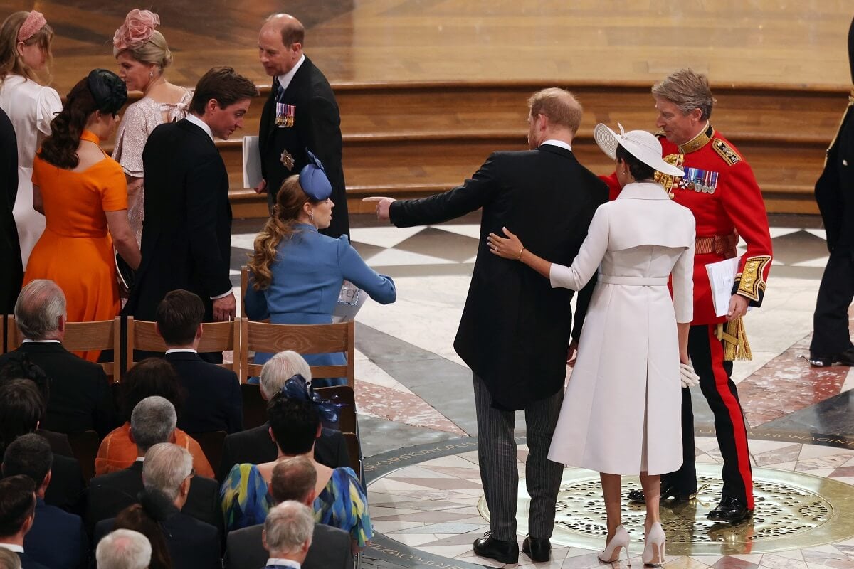 Prince Harry and Meghan Markle being escorted to their seats in the second row at service of Thanksgiving during Platinum Jubilee