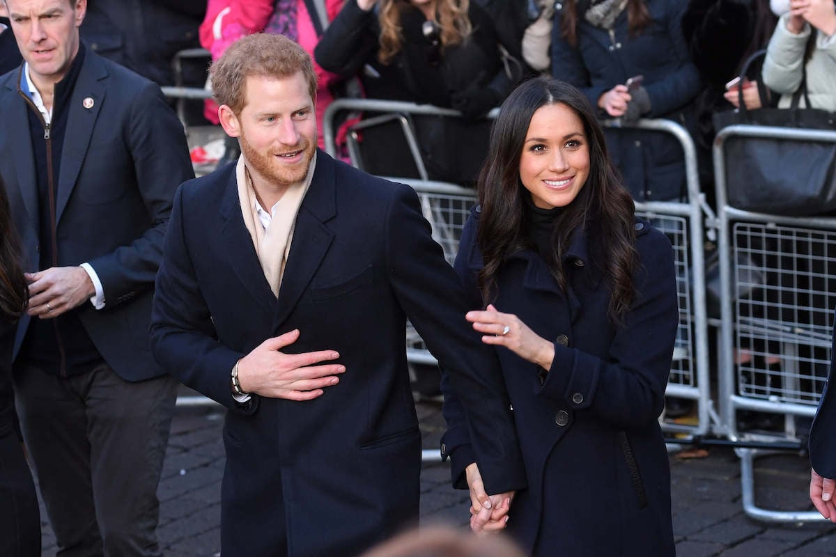 Prince Harry, who called Meghan Markle's first walkabout wardrobe malfunction 'ridiculous,' holds hands with Meghan Markle