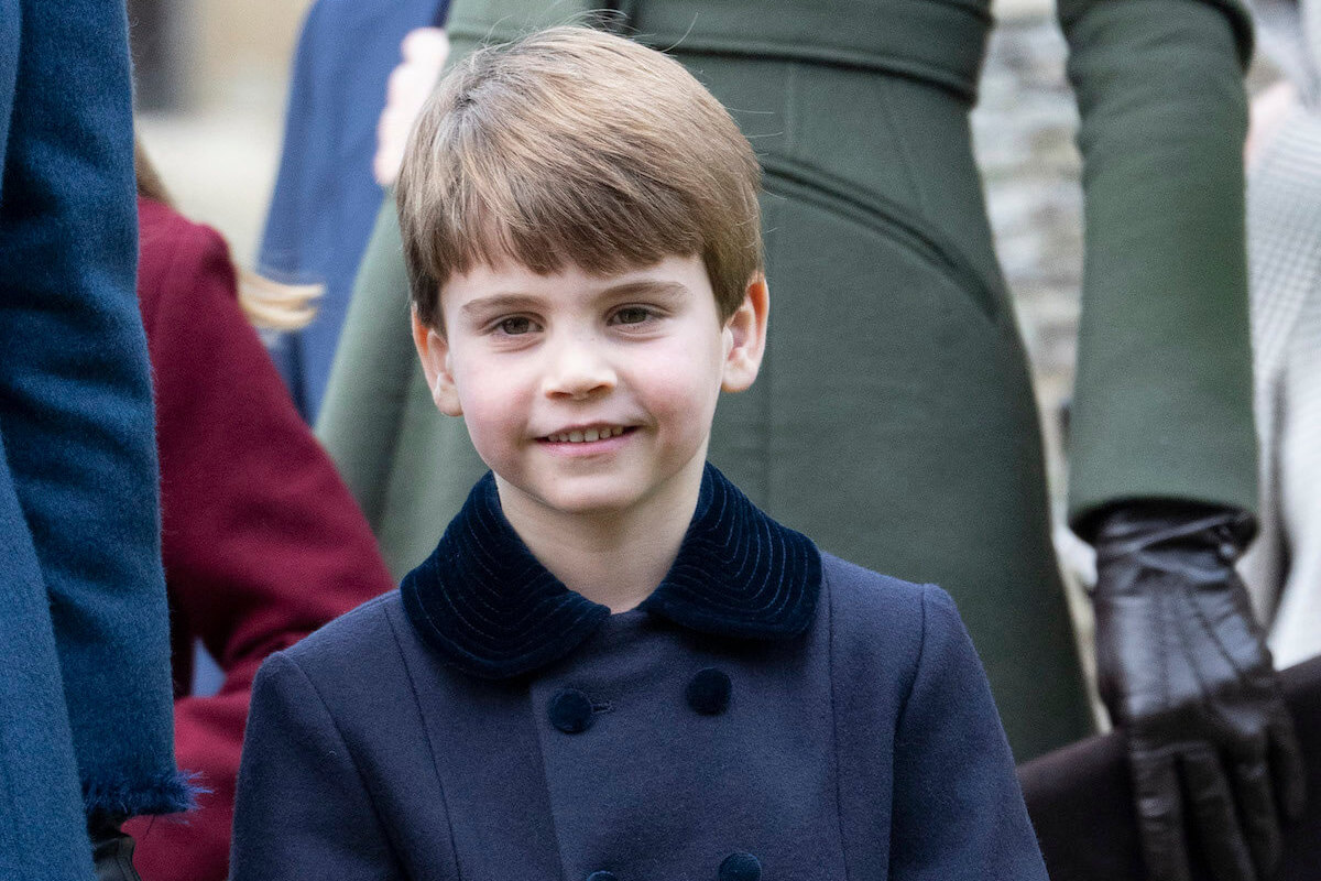 Prince Louis, Prince William and Kate Middleton's youngest children, dubbed a 'double spare', smiles and looks on