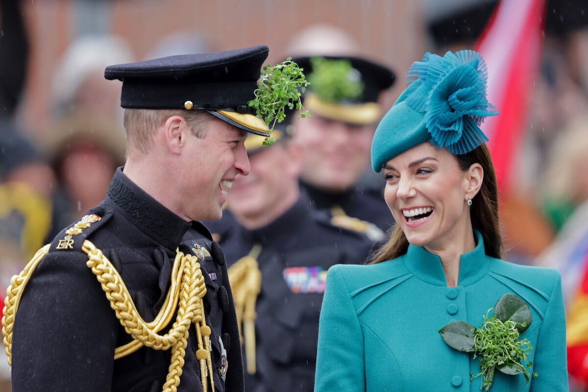 Prince William looking at Kate Middleton and both smiling