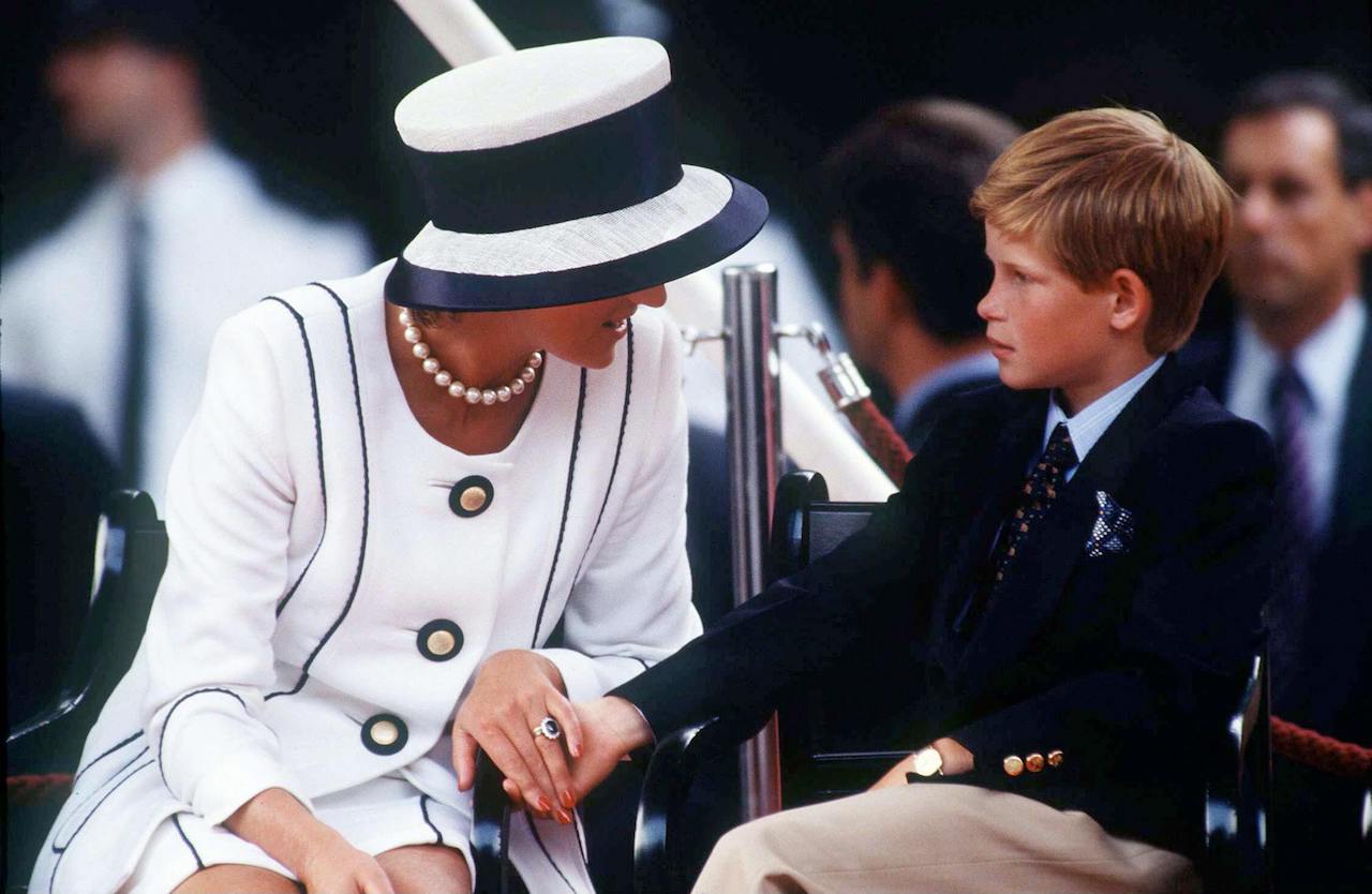 Princess Diana holding Prince Harry's hand in 1995.