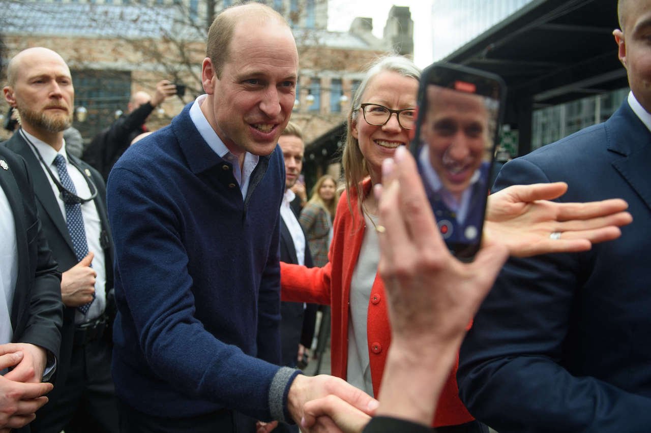 Prince William, Prince of Wales poses for a photo after meeting with a group of Ukrainian refugees during his visit on March 23, 2023, in Warsaw, Poland.
