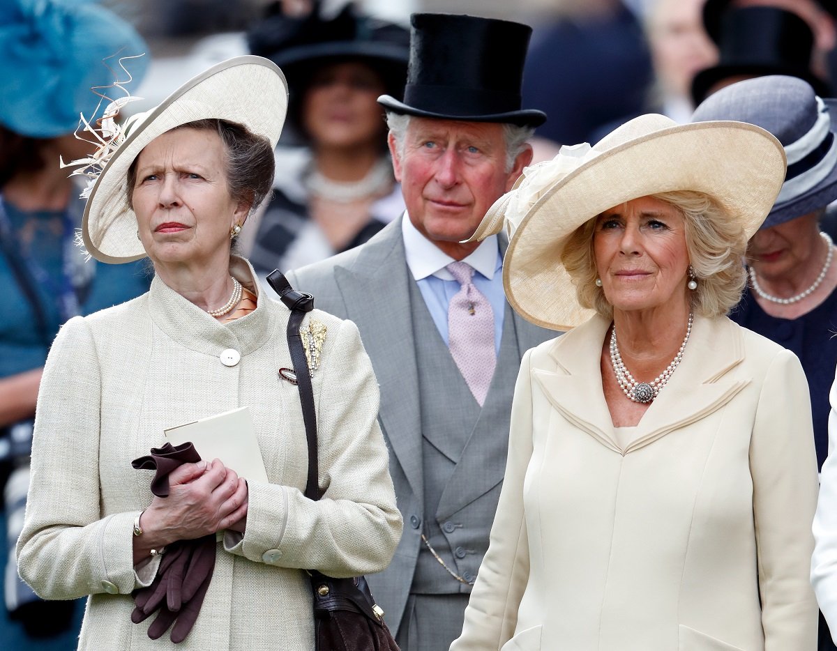 Princess Anne, King Charles III, and Camilla Parker Bowles watch a horse racing at the Royal Ascot