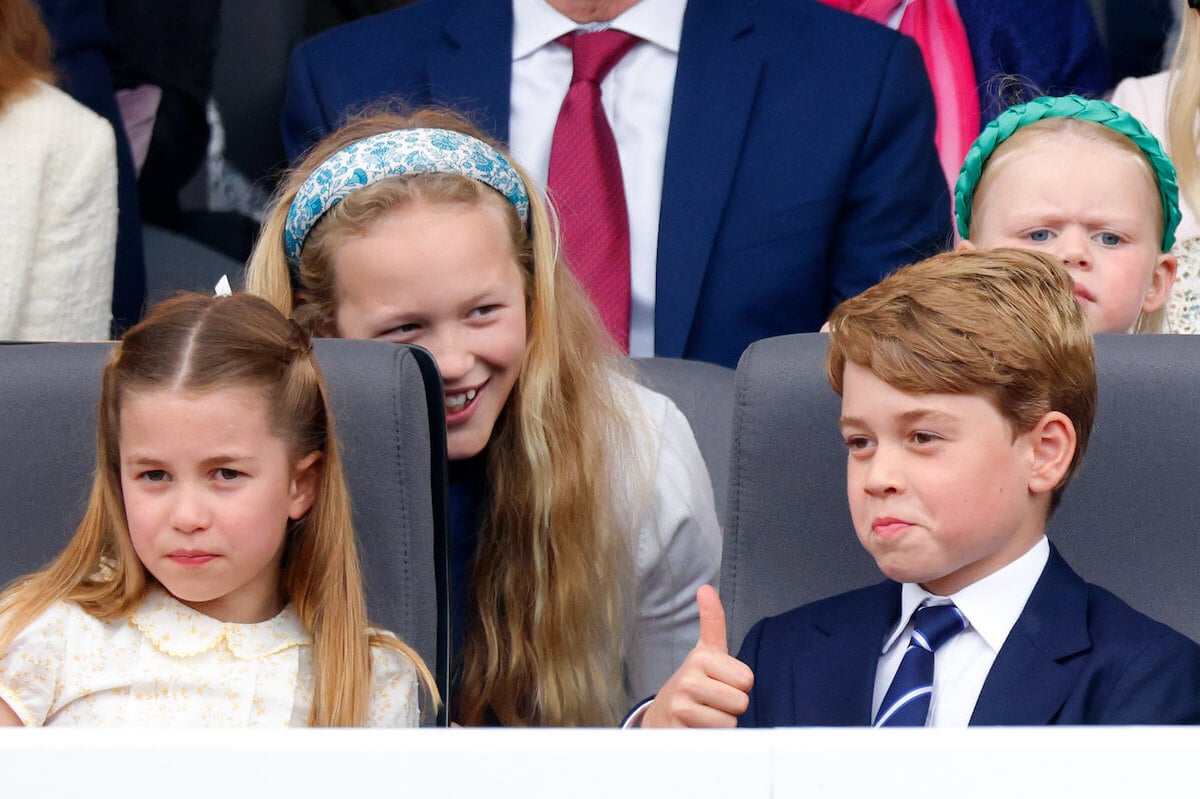 Prince George, whom a body language expert looks up to his cousin, Savannah Phillips, sits with Princess Charlotte and Savannah Phillips