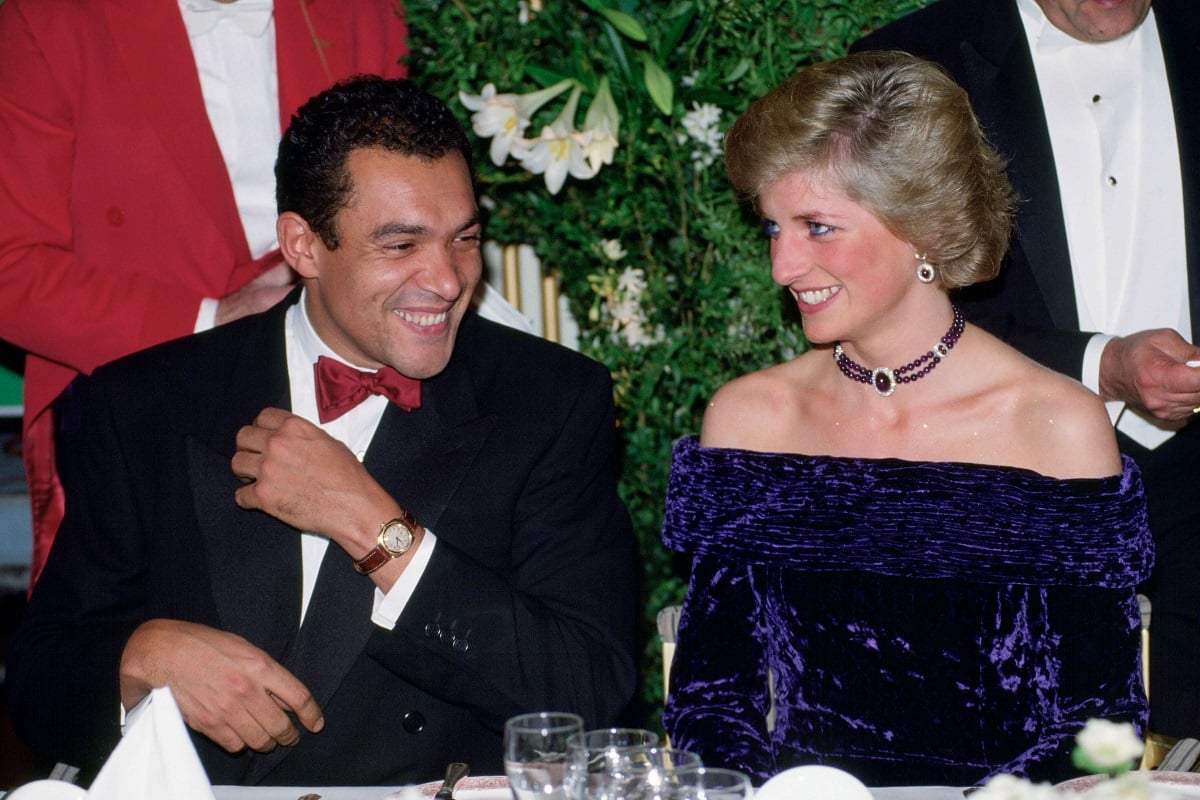 Princess Diana at a charity dinner seated next to Bruce Oldfield who designed her blue velvet dress