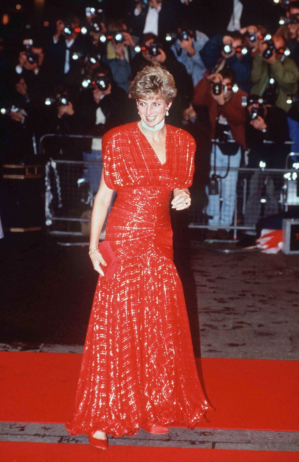 Princess Diana wearing a red dress by Bruce Oldfield at the premiere of 'Hot Shots' 