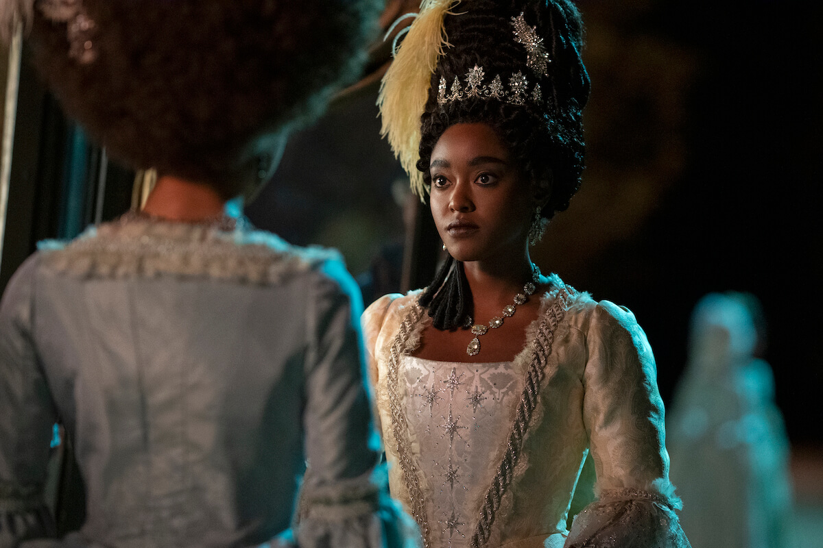 Arsema Thomas as Lady Danbury wearibng a ball gown and a glittering crown in 'Queen Charlotte: A Bridgerton Story'