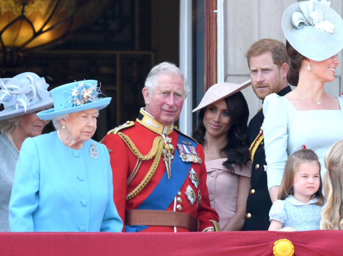 King Charles, whom a historian says made a 'big mistake' evicting Prince Harry and Meghan Markle from Frogmore Cottage, stands with royal family and late Queen Elizabeth II