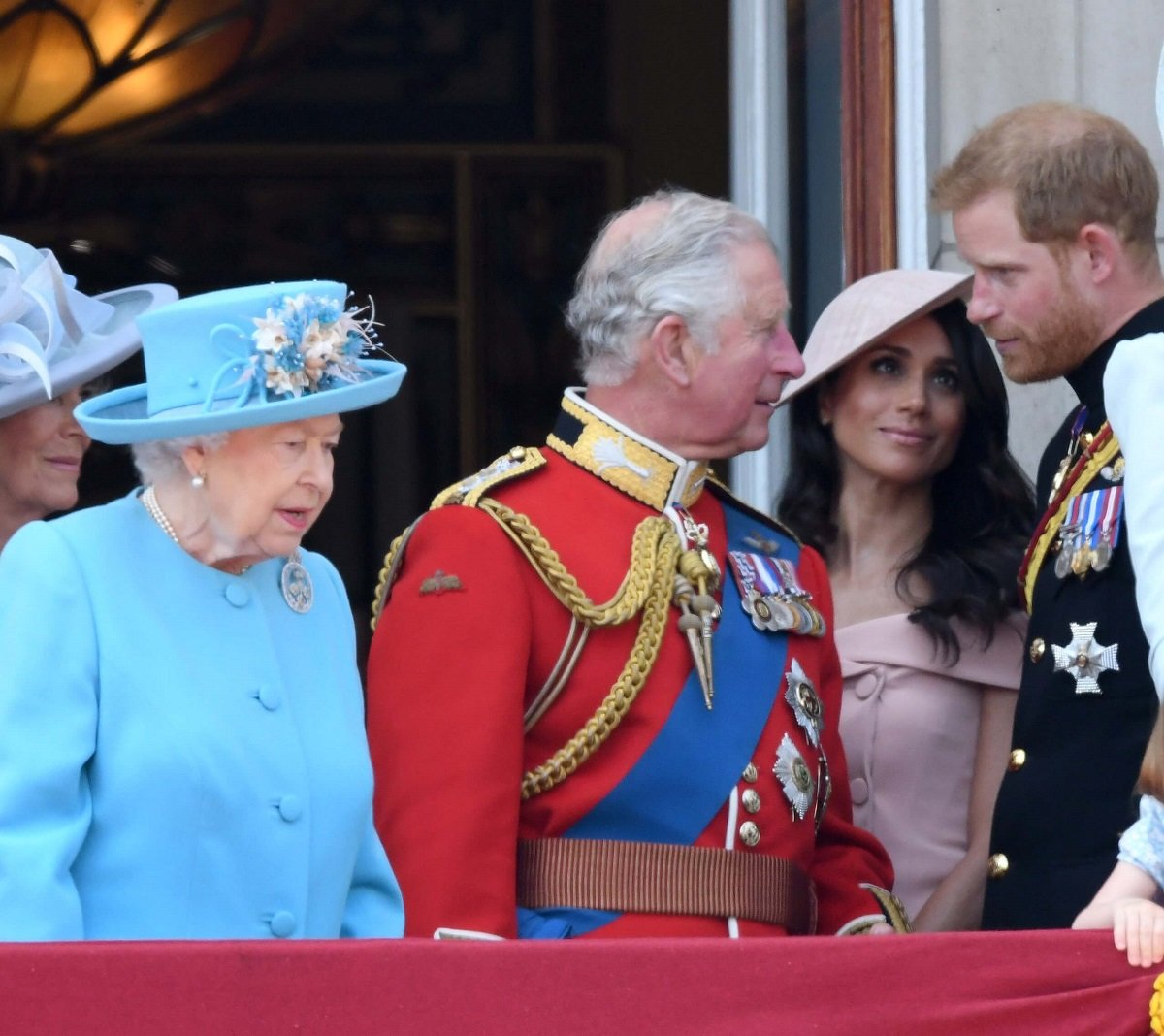 Queen Elizabeth II, then-Prince Charles, Meghan Markle, and Prince Harry standing on the Buckingham Palace balcony during Trooping the Colour